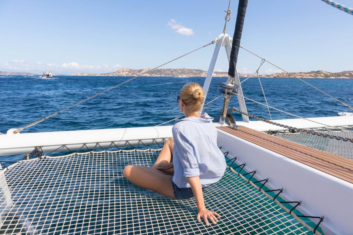 A woman sitting on a net on a boat
