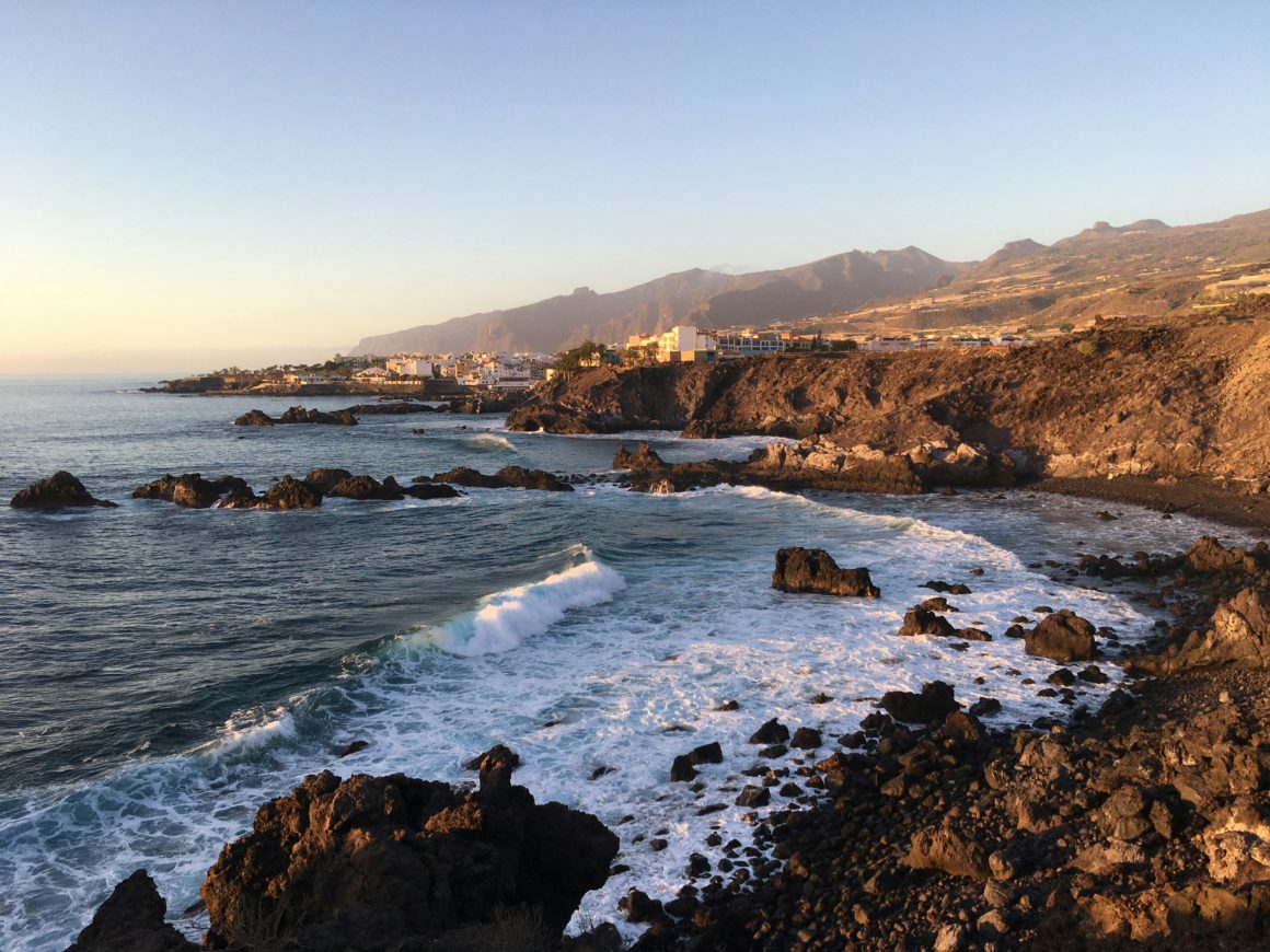 Rocky volcanic coastline at sunset in Tenerife