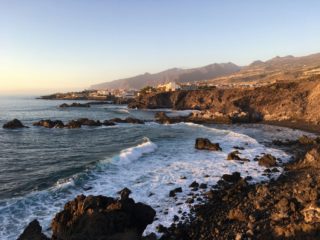 Rocky volcanic coastline at sunset in Tenerife